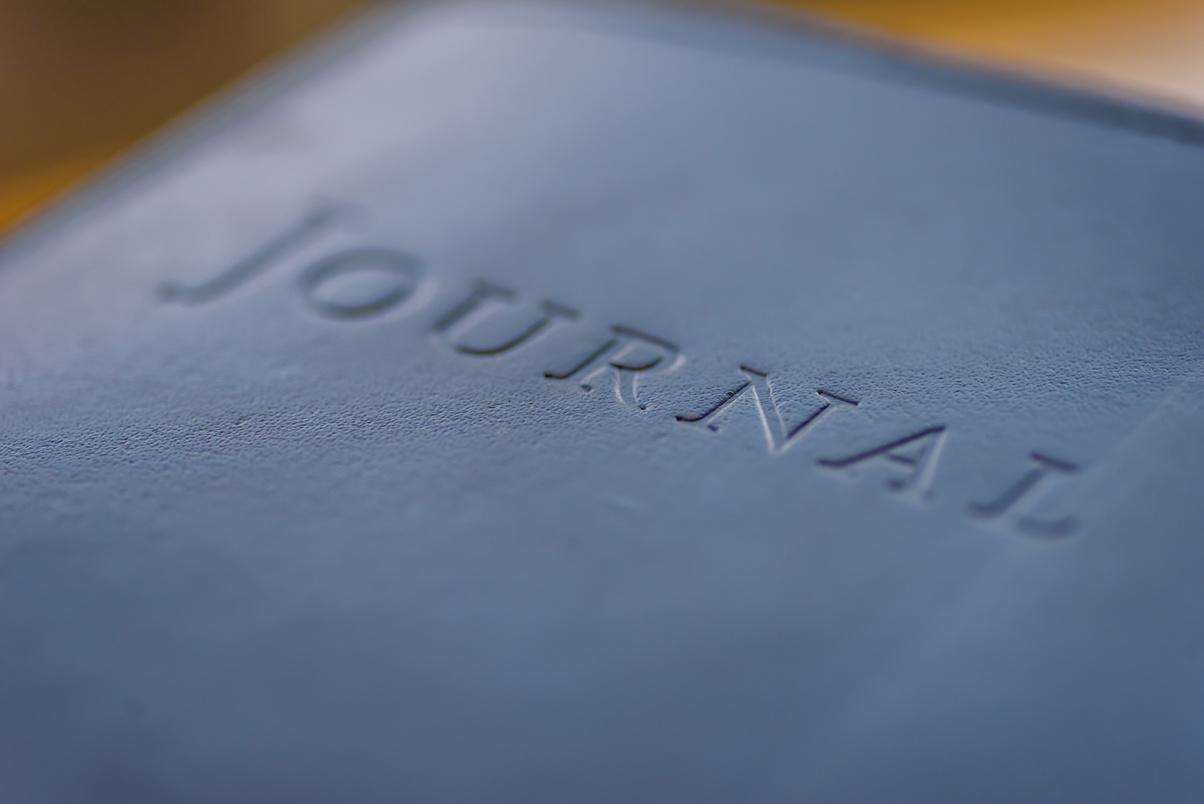 Embossed leather writing journal on table